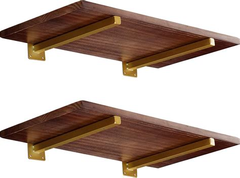 gold colored metal shelf brackets|glass shelves with gold brackets.